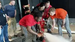 team of students use pitot gauge to test hydrant flow